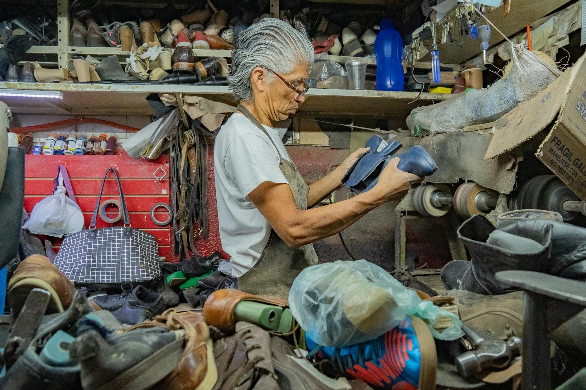 Cobbler repairing a leather shoe